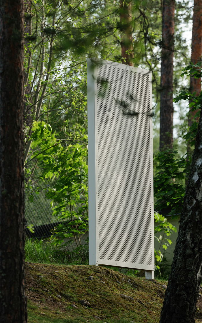 Sculpture, three panels showing a man i profile.